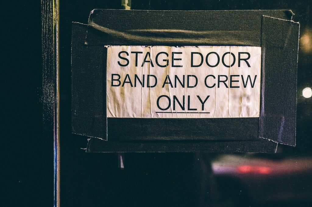 shows sign on a stage door: stage door. band and crew only.