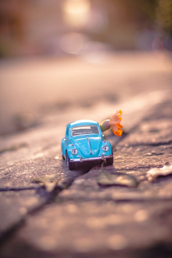 What's your smallest space? Shows a miniature VW Beetle on a pavement with an orange flower.