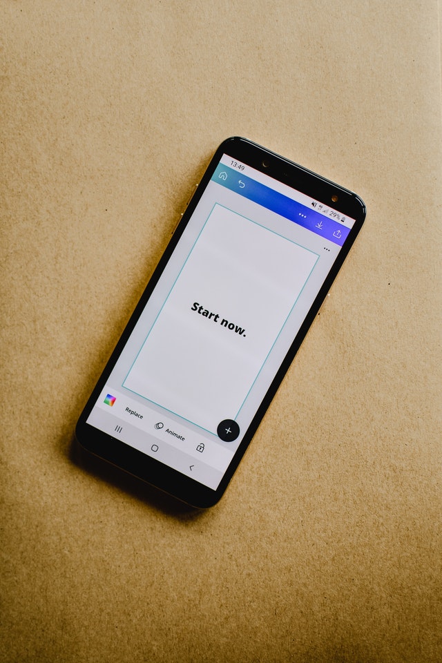Image shows a mobile phone with the words "start now" on the screen