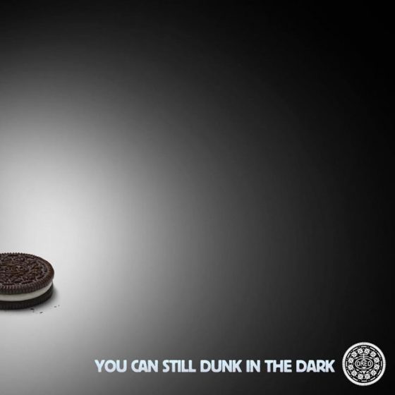 Image is mainly black with a poorly lit Oreo in the bottom left corner. This is the famous Oreo Super Bowl powercut viral content