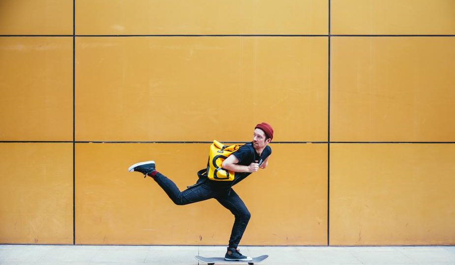 Image shows a skateboarder against a yellow wall. Your catalyst propels your story forward.