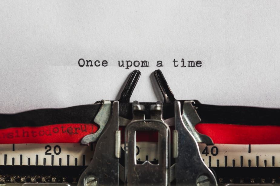 image shows text being typed on an old typewriter. It says once upon a time. Why storytelling is always important to businesses