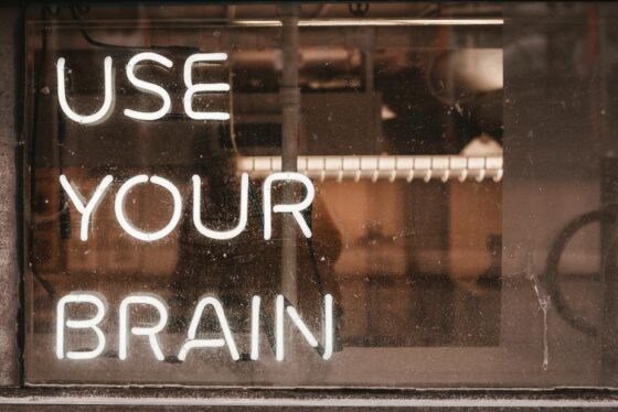 Image shows the words "use your brain" in neon lights