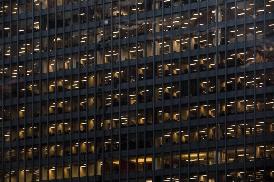 Image shows large number of lit windows in a corporate office block