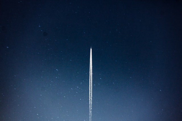 Image shows a rocket blasting into the sky.