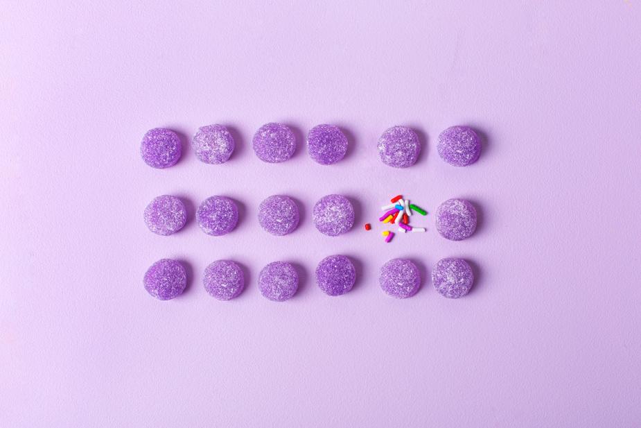 Image shows a lot of purple candies and one pile of sprinkles. Quality over quantity.